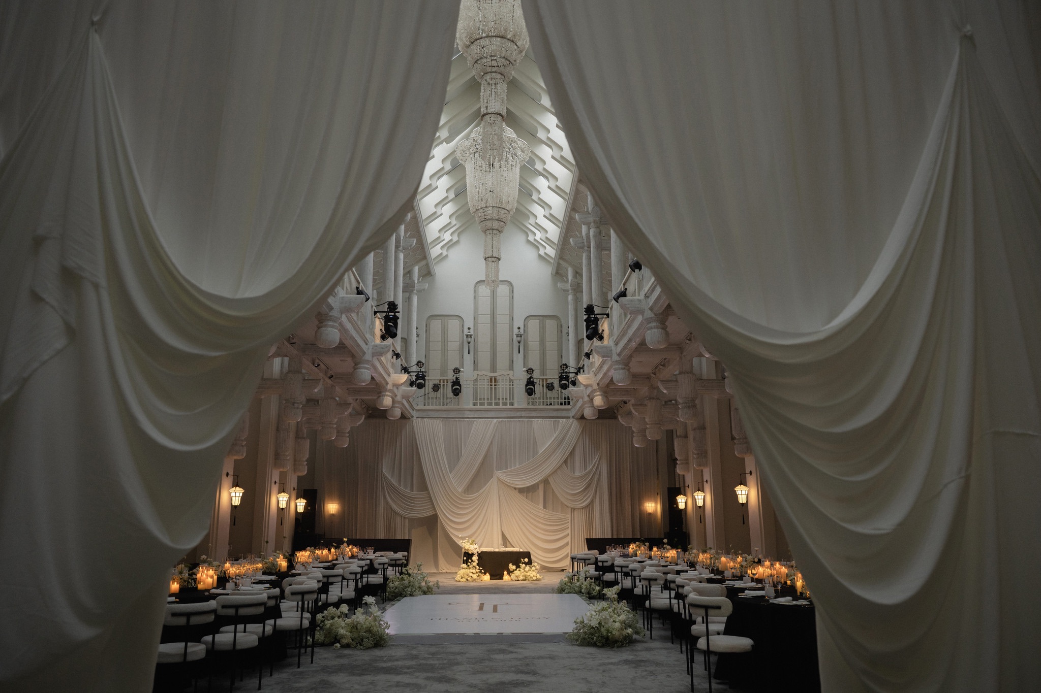 Draped reception hall set for a wedding dinner